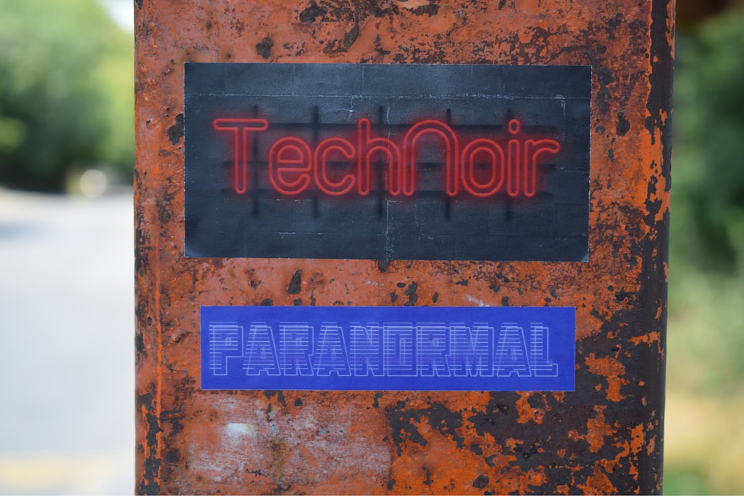 a red and blue sign on a tree