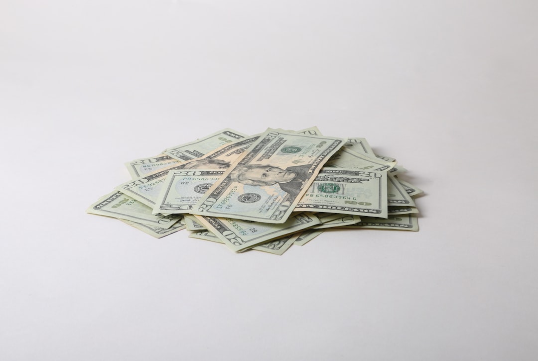 a pile of money sitting on top of a white table