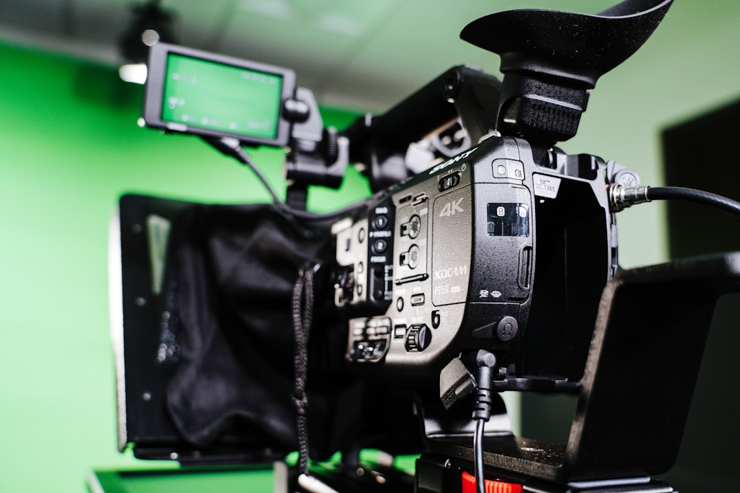 Video camera in a greenscreen studio with a teleprompter.