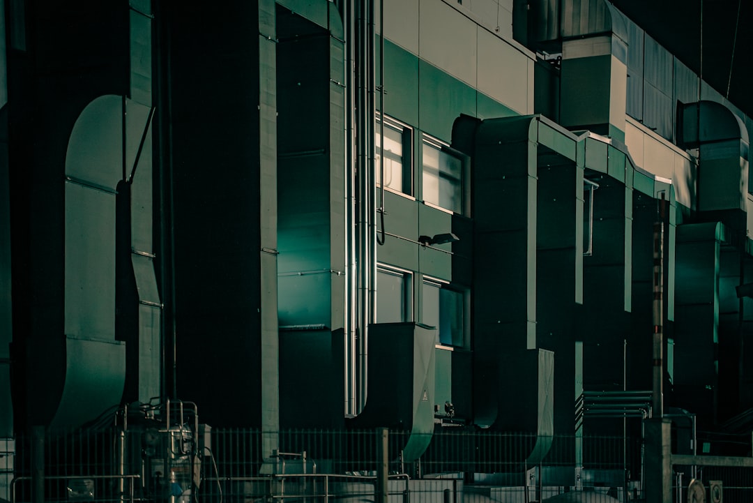 A room filled with lots of tall green and white appliances
