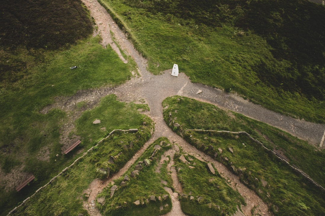 Crossroads in gravel walking paths amoungst the moors of the british countryside.