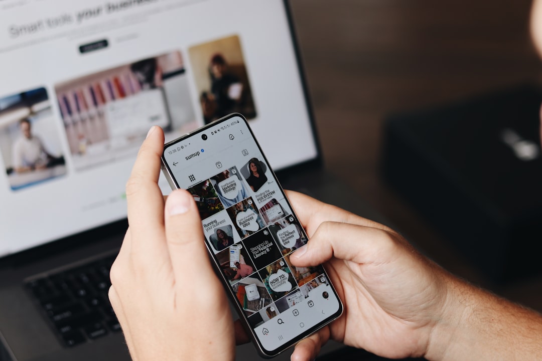 A person is using their smartphone to browse the SumUp Instagram profile, focusing on posts related to marketing strateg